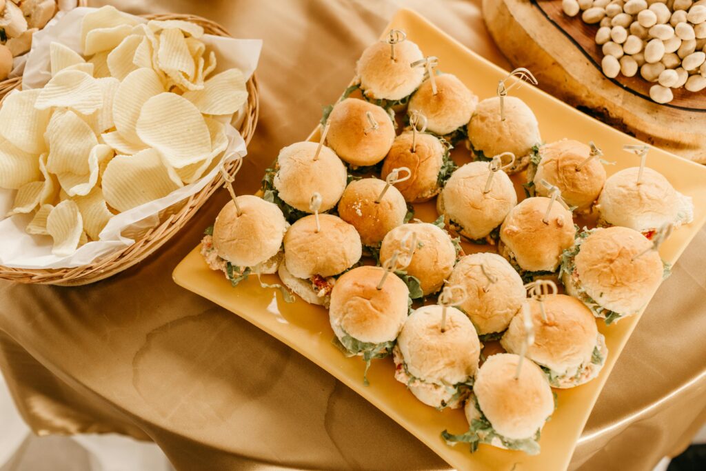 A tempting arrangement of mini sandwiches served with potato chips, perfect for a party or casual gathering.