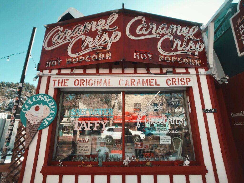 Iconic Caramel Crisp snack bar offering taffy and hot popcorn in Estes Park, Colorado.