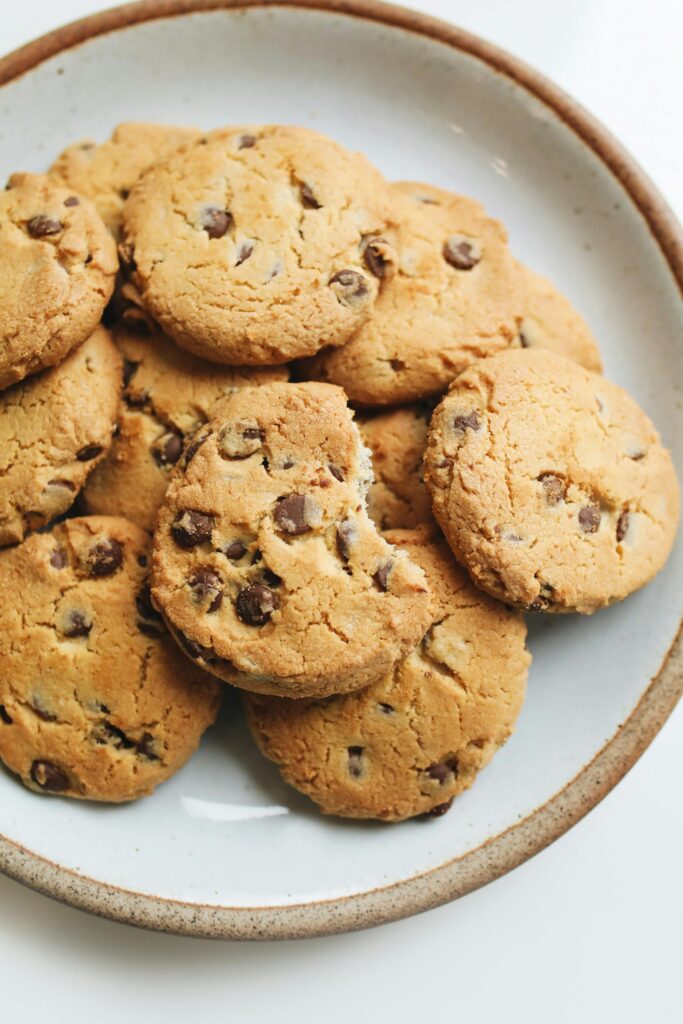 A plate of freshly baked homemade chocolate chip cookies, perfect for dessert.