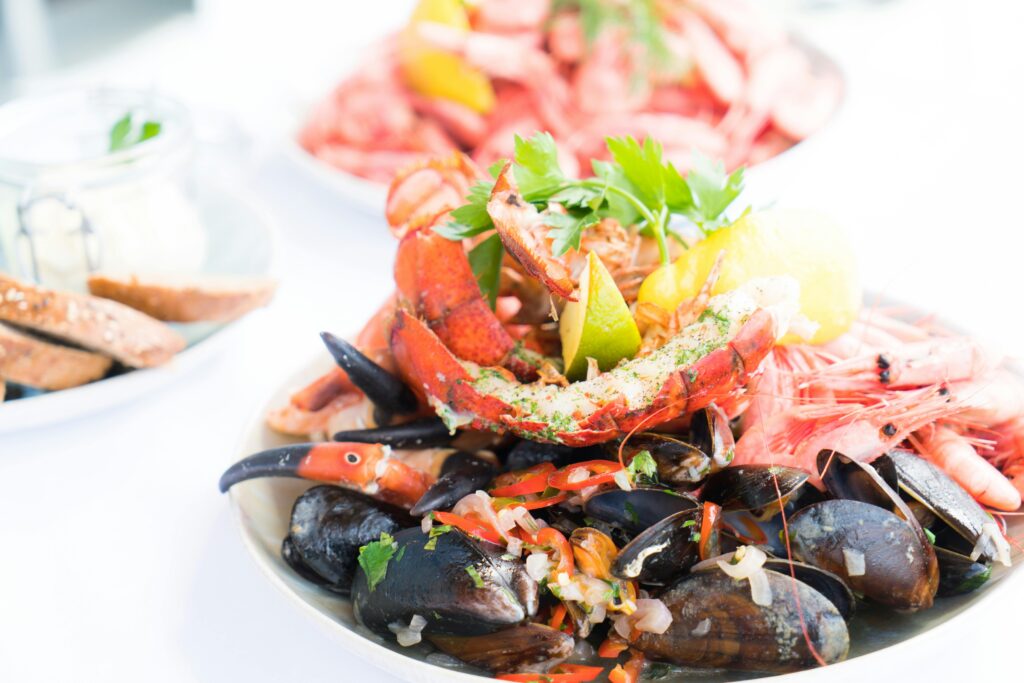 A vibrant seafood platter featuring lobster, mussels, and shrimp, garnished with herbs and lemon.