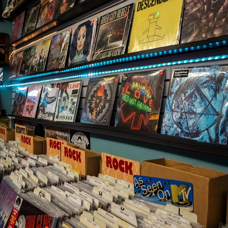 Vibrant collection of vinyl records showcased on shelves in an indie music store.